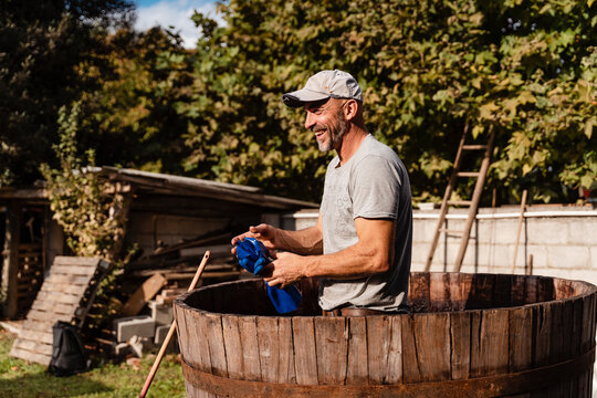 49 years old wine maker working to produce new wine for his winery