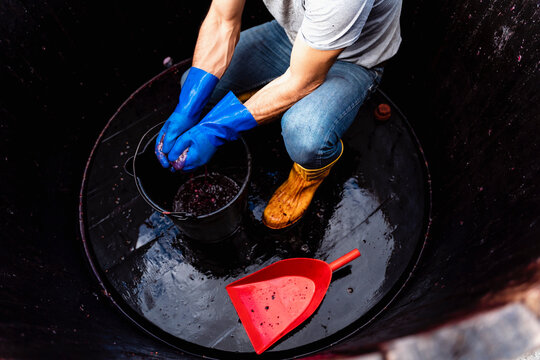 49 years old wine maker working to produce new wine for his winery