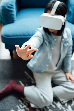 Teenager girl wearing VR glass at home