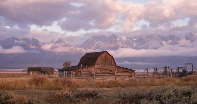 A barn in the Wyoming countryside with the Grand Teton mountains in the background