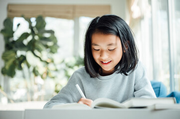 Teenager girl doing homework at home