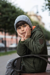 portrait of a five-year-old boy in the city in the fall.