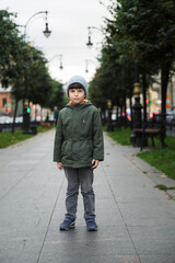 portrait of a five-year-old boy in the city in the fall.