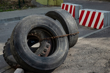 worn old tires as a barrier to obstruct traffic