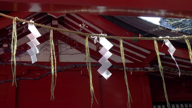 Torii and shide (sacred paper) at a Japanese shinto shrine.