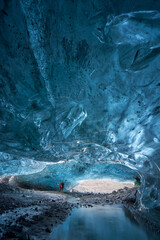 Tourists exploring an Ice Cave in Breiðármerkurjökull outlet glacier, Vatnajökull National Park, Southeast Iceland.
