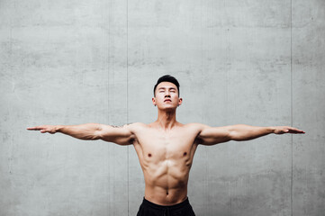 Portrait bare chested man with arms outstretched