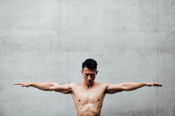 Portrait bare chested man with arms outstretched