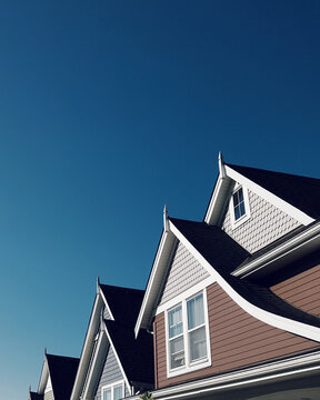 Row of house gables with clear, blue skies as background.