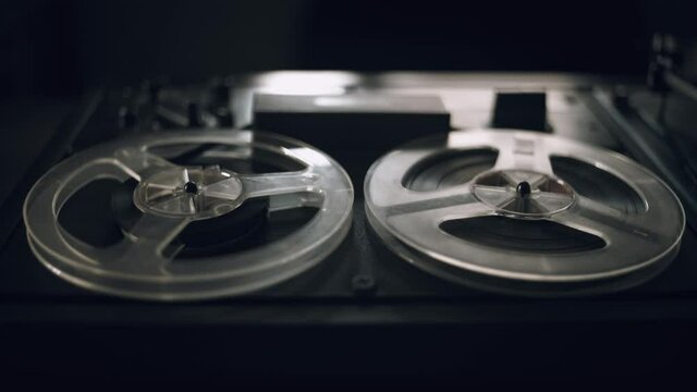 Vintage Tape Recorder Roller. Reel film tape is rotating at a vintage professional player. Oldschool concept