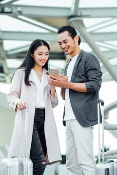 Business people using cell phone in airport