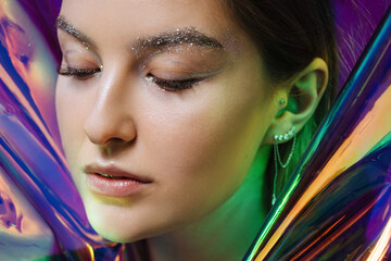 Beauty portrait of pretty woman on holographic background