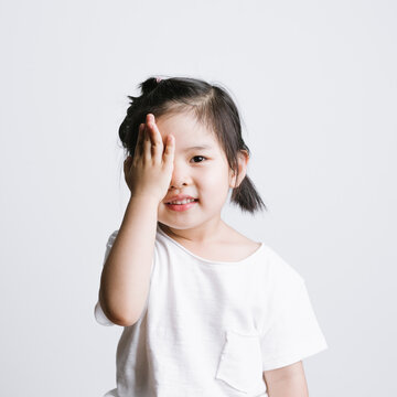 Portrait of cute little girl against white background
