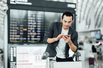 Business people traveling at airport and pushing trolly