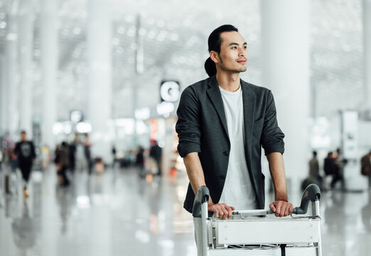 Business people traveling at airport and pushing trolly