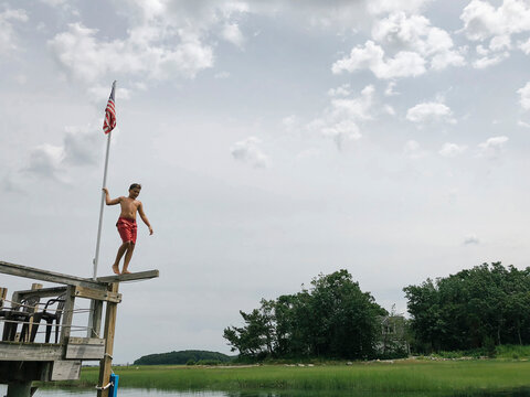 Young Boy Walking Jump Off of Dock