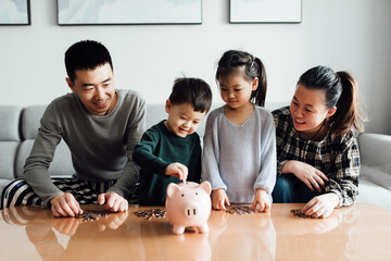 Family saving money in a piggybank