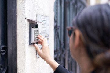 Woman opening a door using a code lock