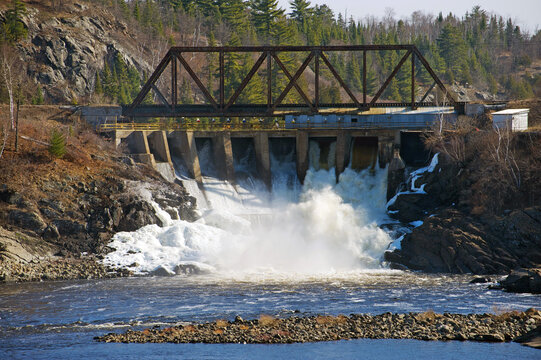 A view of the dam portion of a pulp and paper mill which uses water, energy and wood pulp to produce paper.
