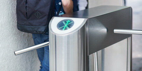Concept photo of man passing a turnstile gate