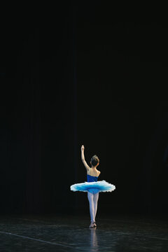 Asian girls perform ballet on stage