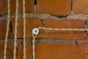 retro old design imitation of electric fuses with electric wires on a red brick wall background 