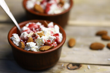 Selective focus. Macro. A bowl of cottage cheese with topping and almonds. Healthy food concept. Diet lunch or breakfast. The keto diet.