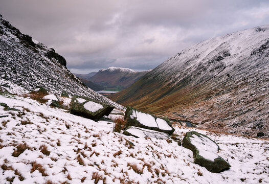 Snow over Kirkstone Pass at sunrise, with Borther Water beyond. Cumbria, UK.