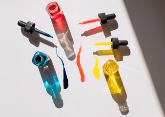 Bottles and pipettes with colorful liquids