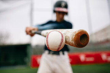 Batter hitting baseball ball with bat
