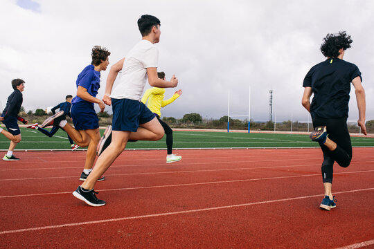 Teenagers running race on stadium