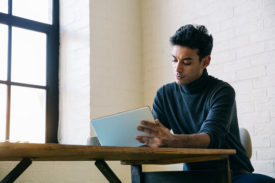 Man using tablet at desk