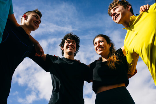 Teen athletes hugging each other