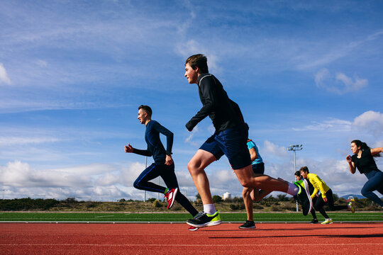 Teenagers running race on stadium