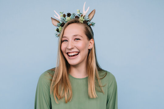 Laughing woman in floral deer headband