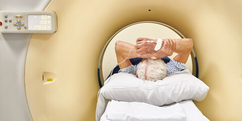 Concept photo of senior man inside CT scanner