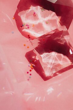 Crystal and small stars on pink background