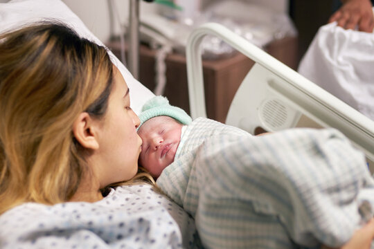 Hapy mother and newborn child in a hospital