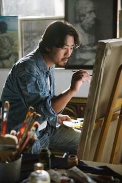 Male artist woking in studio