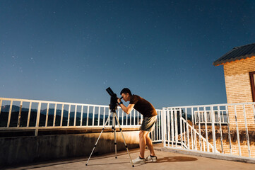 Men looking at stars with telescope
