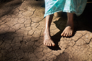 Photo of anonymous old woman during a drought