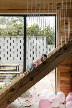 A young kid playing on a slide.
