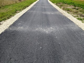 fresh asphalt in the field in the evening
