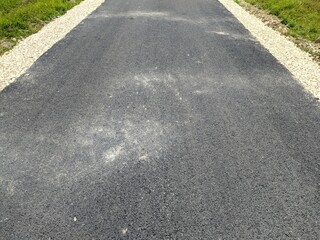 fresh asphalt in the field in the evening