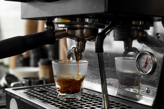 Espresso machine pouring shot into glass cup