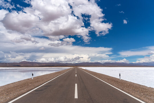An empty Road surrounded by Salt Flats
