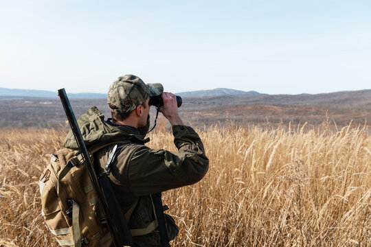Hunter stalking prey near hills