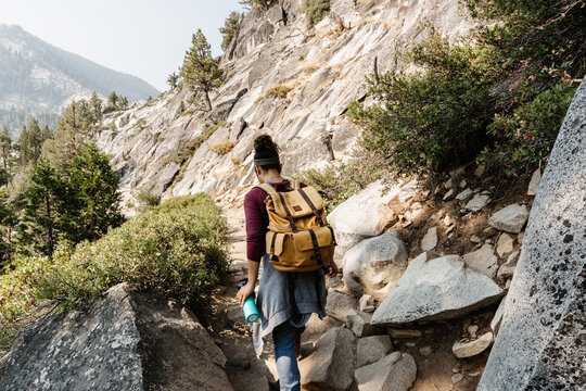 Tourist with backpack hiking in mountains at Lake Tahoe in California, USA