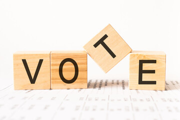 Word vote. Wooden small cubes with letters isolated on white background with copy space available.Business Concept image.