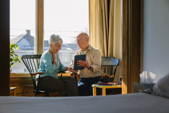 Senior Citizen Couple Laughing while Looking at Computer